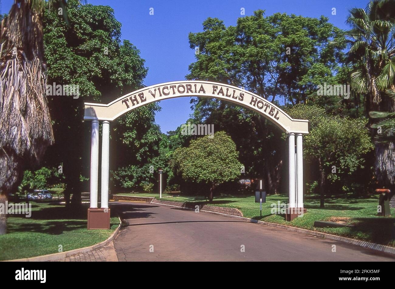 Entrance arch to Victoria Falls Hotel and gardens, Victoria Falls, Matabeleland, Zimbabwe Stock Photo