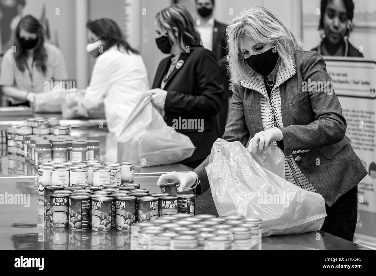 First Lady Jill Biden packs canned goods into bags for children in the Buddy Backpack program Friday, Feb. 26, 2021, at the Houston Food Bank in Houston. (Official White House Photo by Katie Ricks) Stock Photo