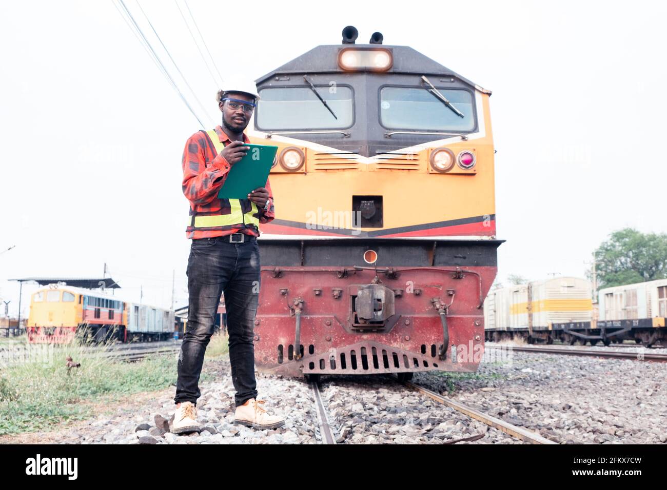 African engineer   control and check report of the train on railway Stock Photo