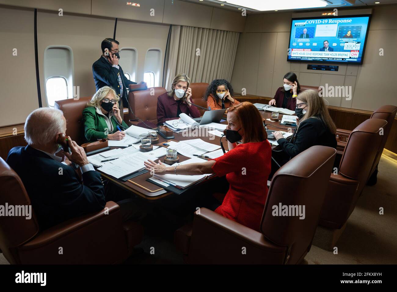 President Biden First Lady Jill Biden and members of the senior staff listen to a briefing in the conference room on Air Force One en route to Houston Texas on Tuesday Feb