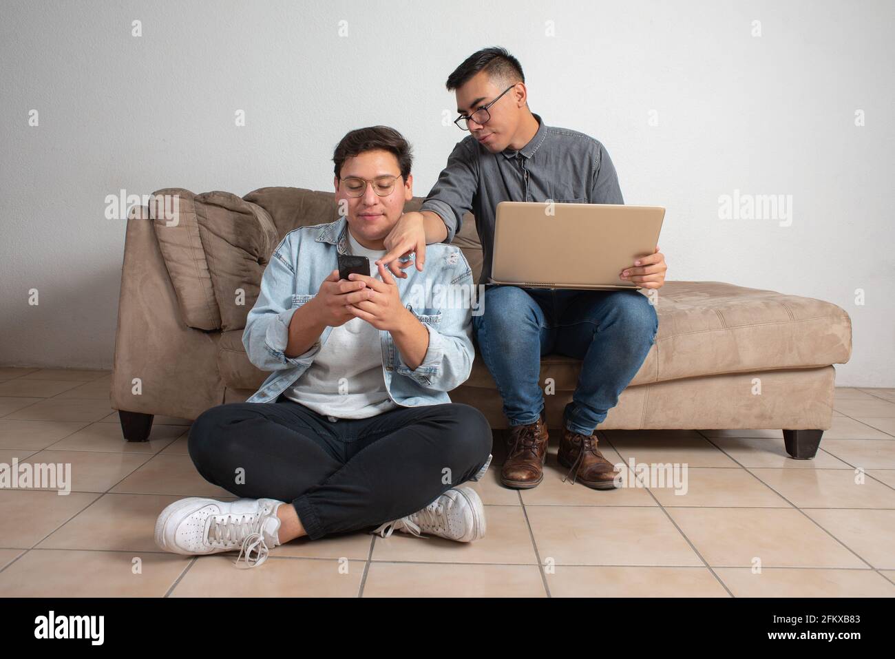 gay couple with laptop, online communication, technology problems, education Stock Photo