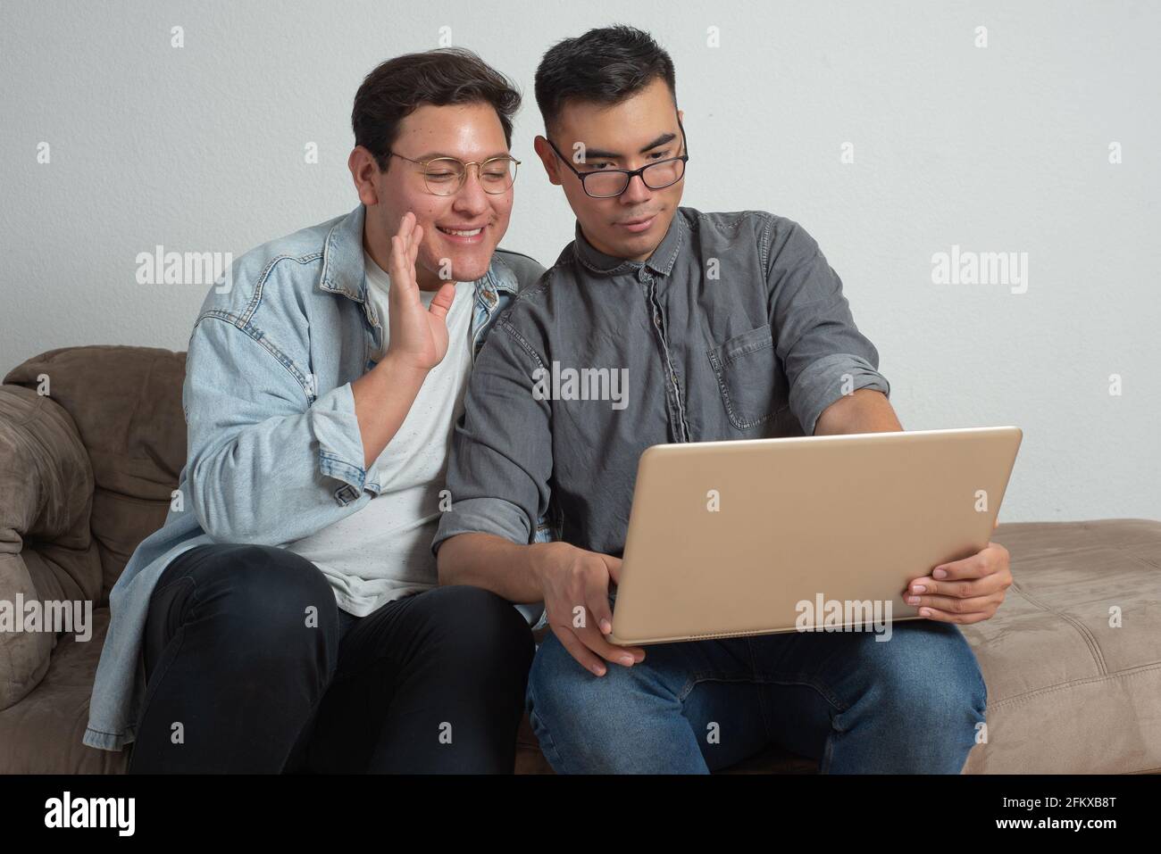 gay couple with laptop, online communication, technology problems, education Stock Photo