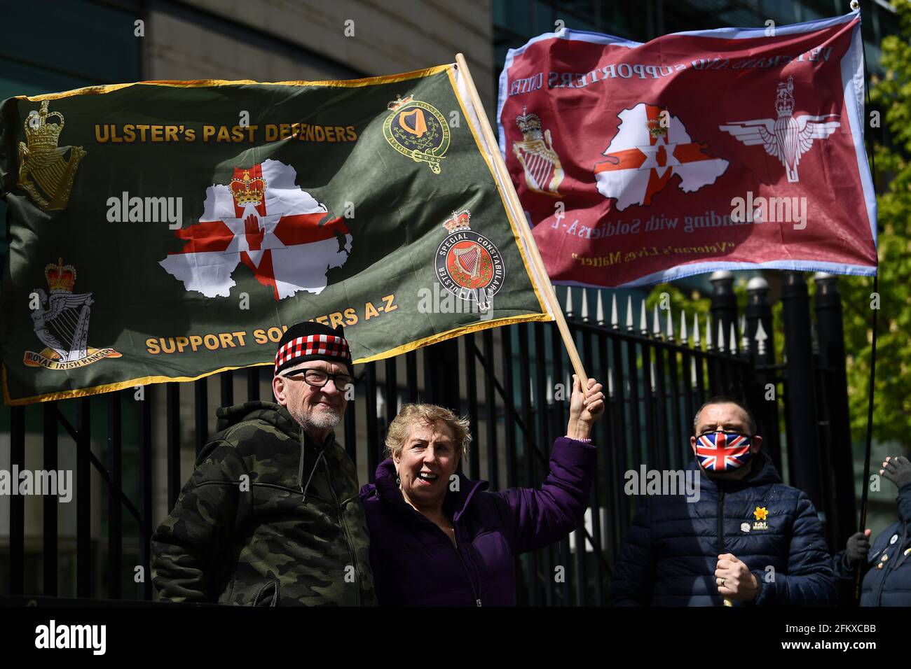 People hold flags outside Laganside Courts during the trial into the 1972 killing of official IRA member Joe McCann, in Belfast, Northern Ireland, May 4, 2021. REUTERS/Clodagh Kilcoyne Stock Photo