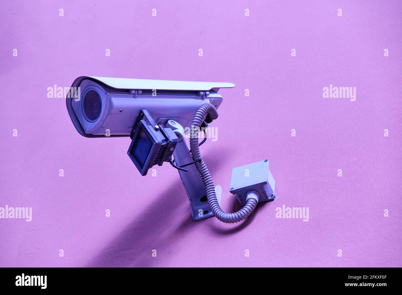 security camera on pink background Surveillance Cameras Stock Photo