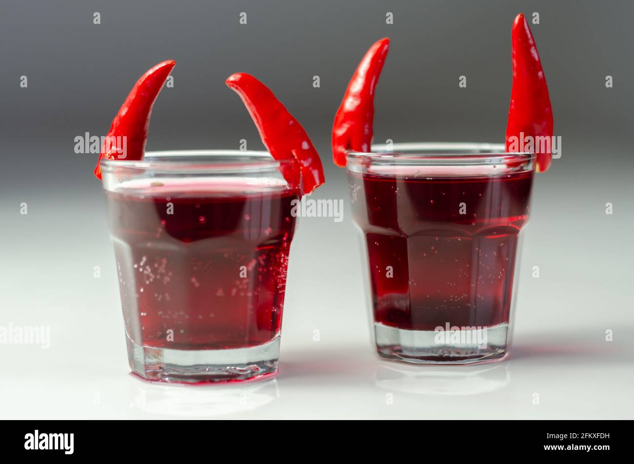 Drink shot prepared with vodka, grenadine and lemon juice decorated