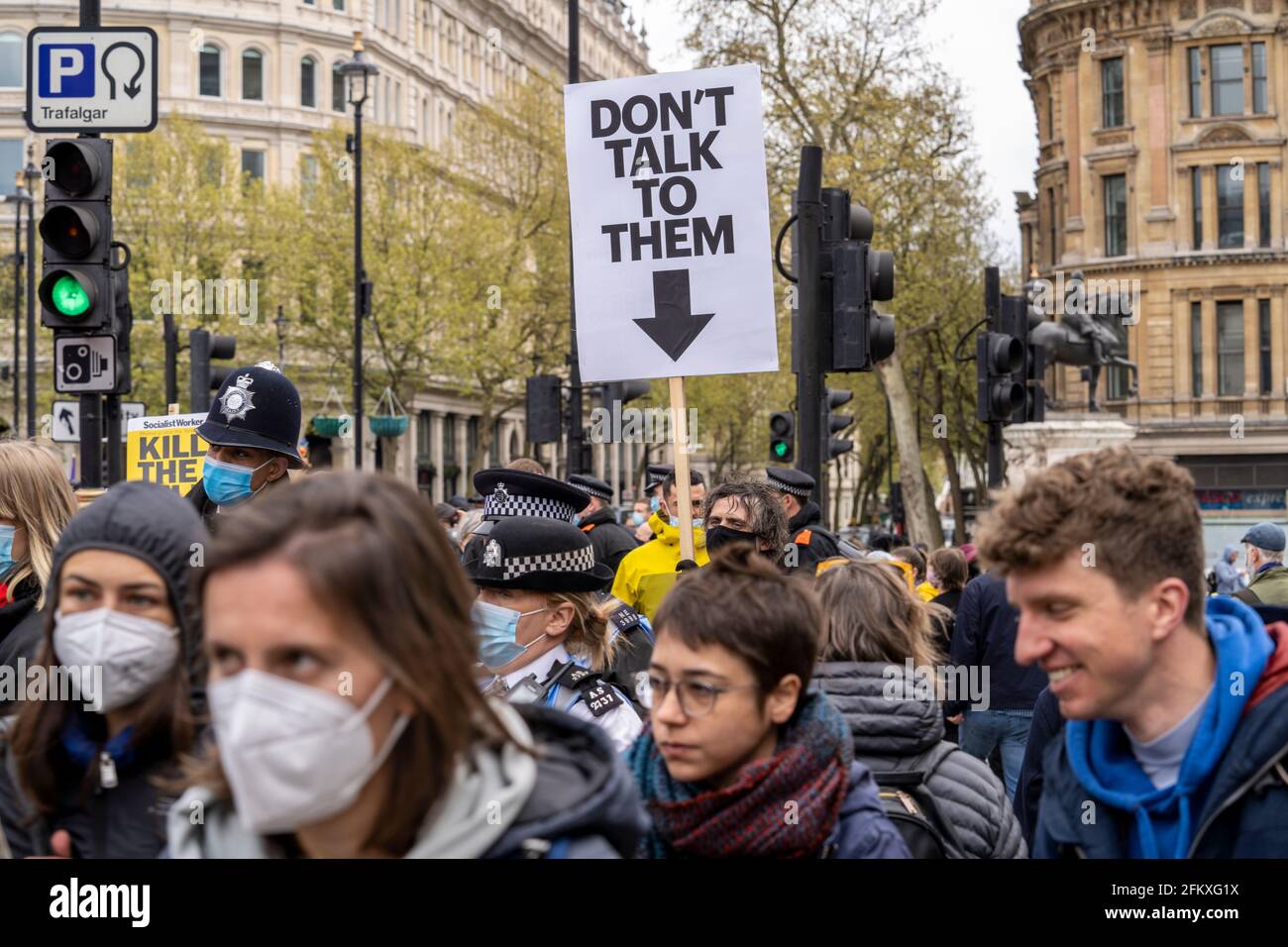 LONDON, UK – 01st May 2021: A man holds a sign saying don’t talk to them above the heads of police officers during a Kill the Bill demonstration Stock Photo