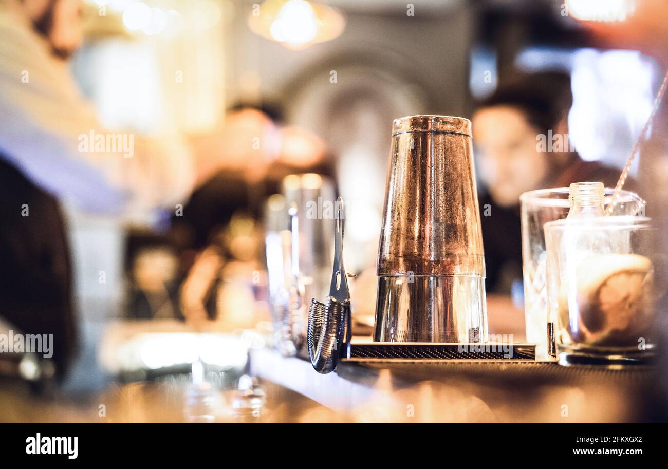 Blurred defocused side view of barman preparing drink to guest at speakeasy cocktail bar - Social gathering concept with people enjoying time together Stock Photo