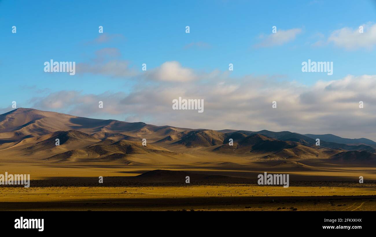 desert landscape on a bright sunny day, showing the clouds moving overhead. Stock Photo