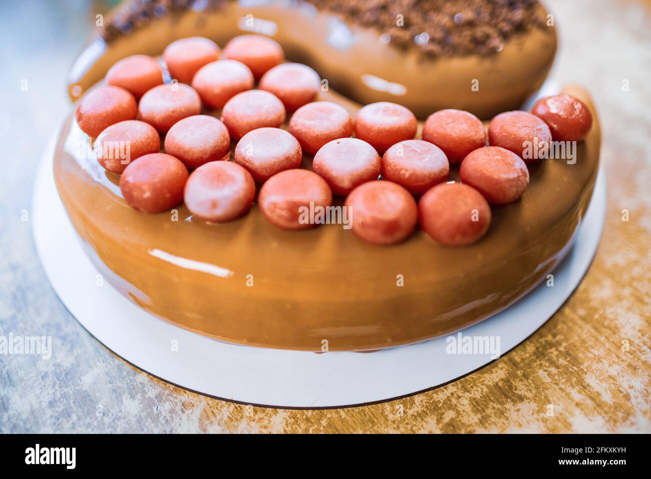 Lovely delicious cake in the shape of Yin-Yang in the home kitchen on a wooden table Stock Photo