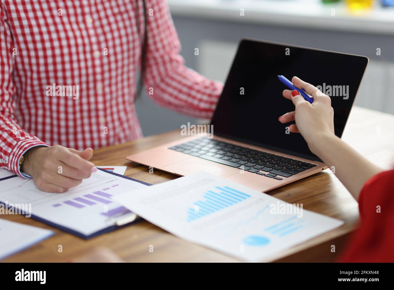 Partners at working table discuss business processes Stock Photo Alamy