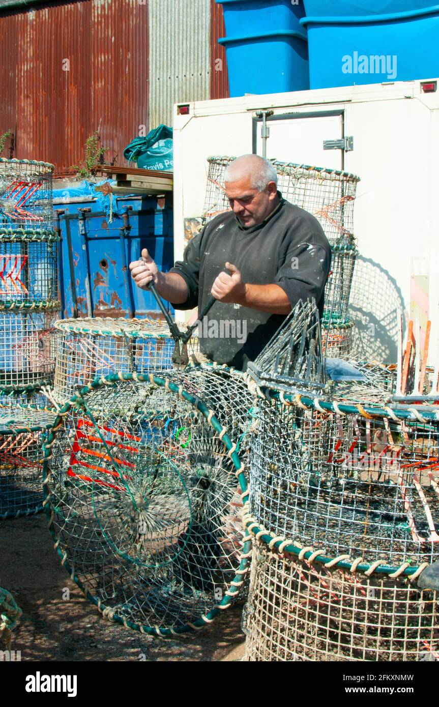 cuttle fisherman mending traps Stock Photo