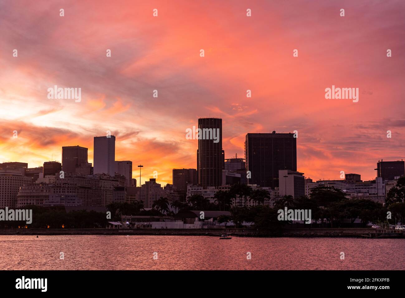 Beautiful sunset view to orange clouds over downtown buildings Stock Photo
