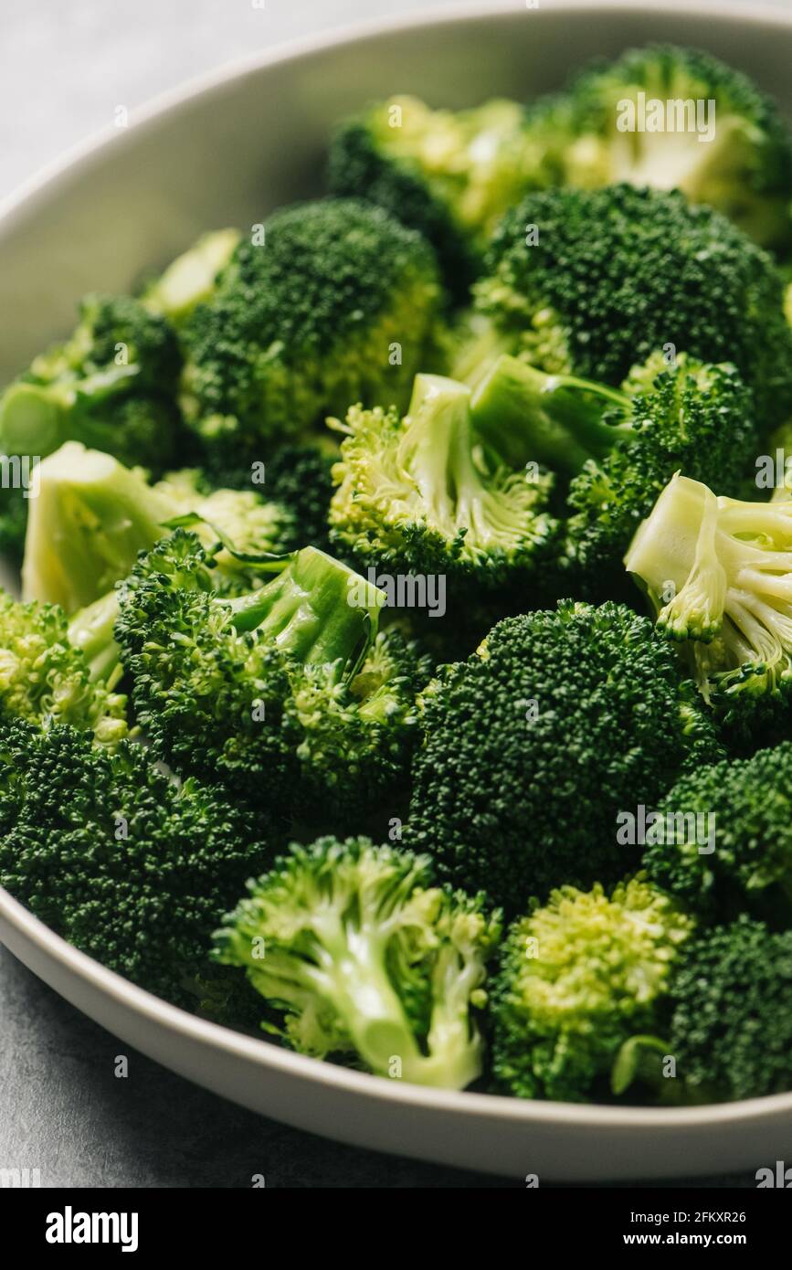 Cooked broccoli florets in a bowl Stock Photo Alamy