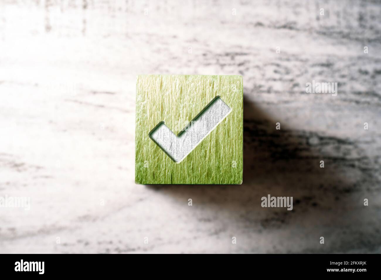 Check Mark On A Green Wooden Checkbox Block On A Table Stock Photo - Alamy