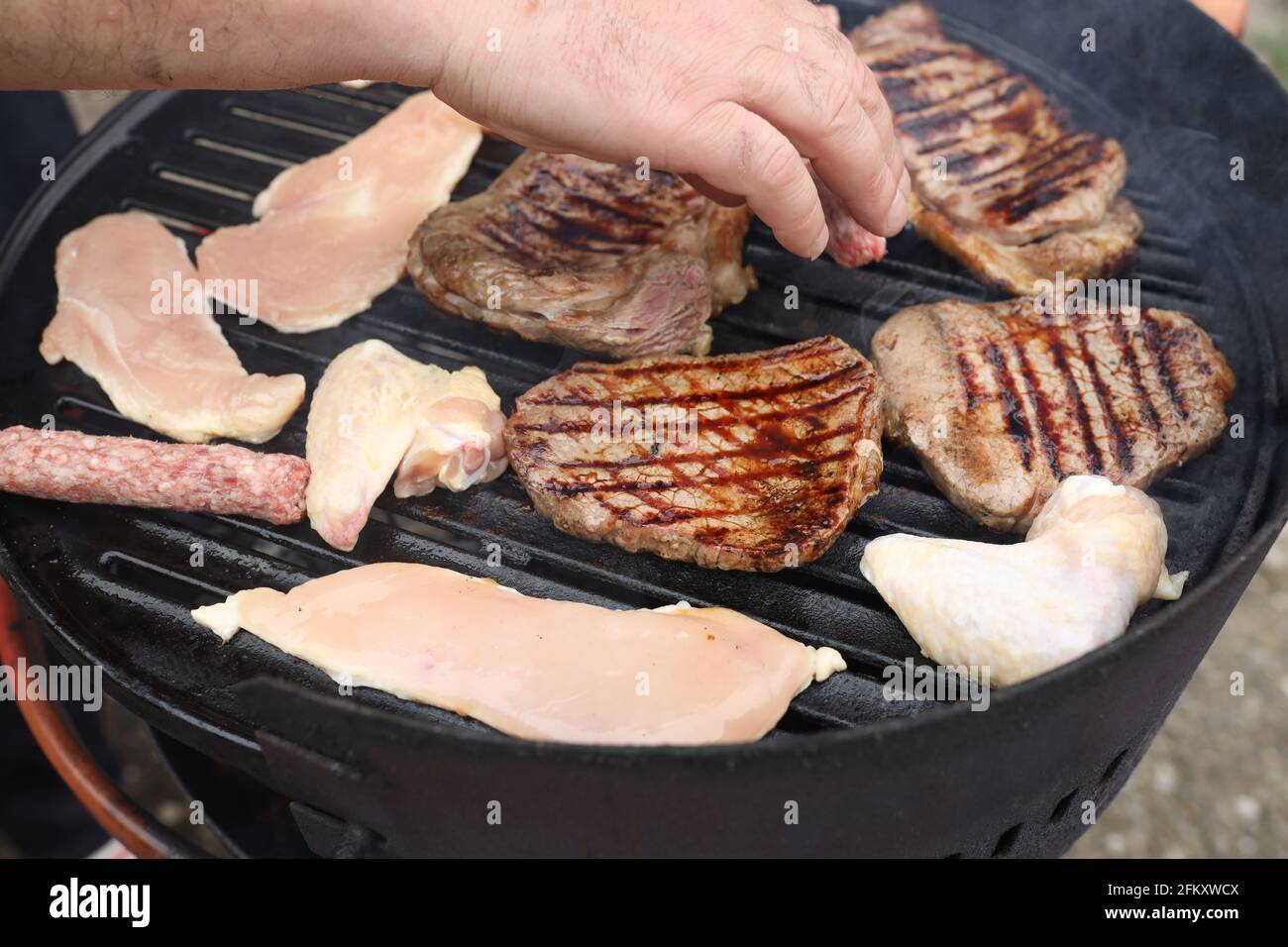 Process of making barbecue with meat fillets on a grill Stock Photo Alamy