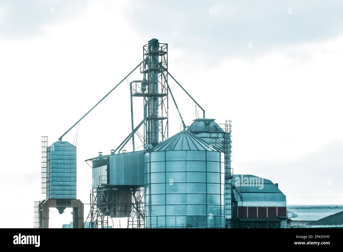 Silo tower for storing and protecting feed, grain or cement from exposure to water and air. Silo industry, manufacturing, storage tanks on agriculture Stock Photo