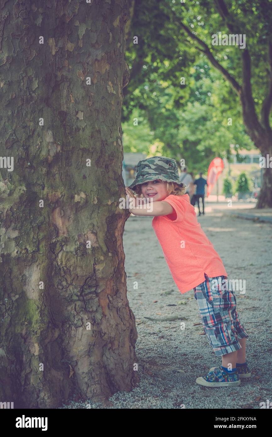 Young Boy playing under a Tree Stock Photo