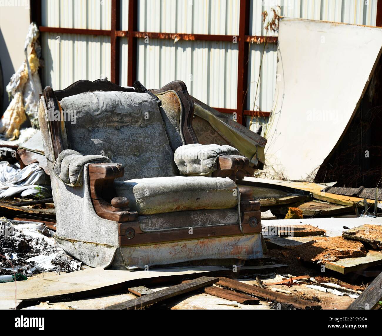 Storm took out the walls, roof and floor of this building.  Easy chair sits exposed to the elements as the one piece of furniture remaining. Stock Photo