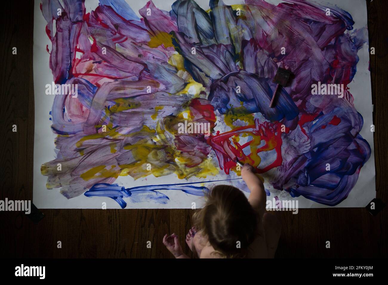 Overhead view of young toddler and their fingerpaint project Stock Photo