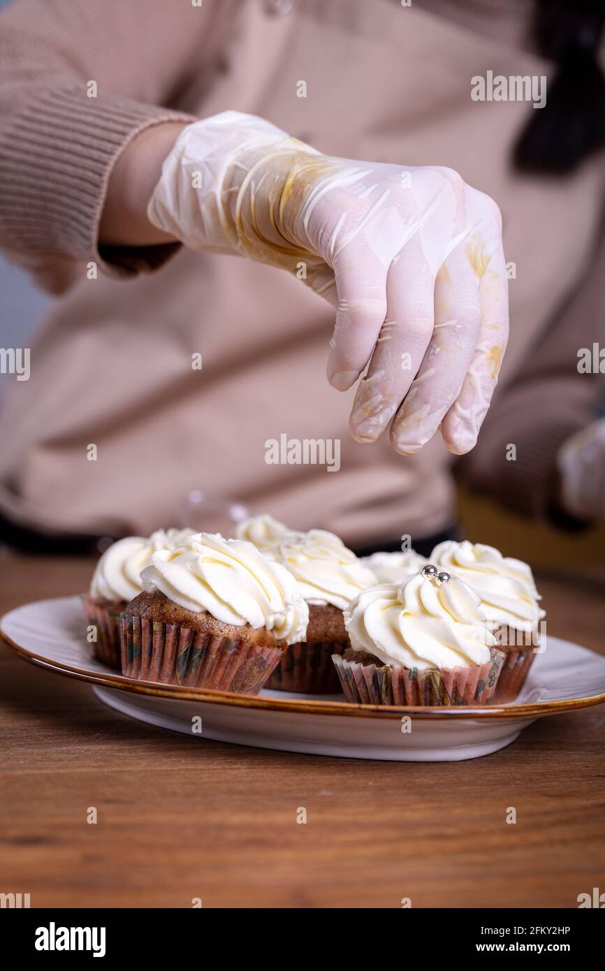 making cupcakes with cream close-up with the hands of the chef Stock Photo