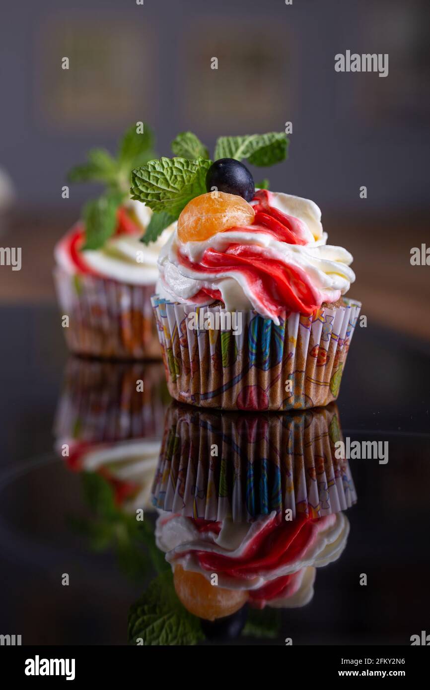 Delicious tasty muffins with reflection close up Stock Photo - Alamy