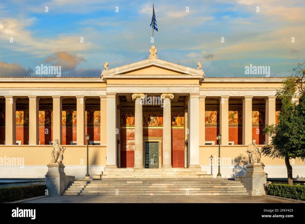 Athens, Attica, Greece. The National and Kapodistrian University of Athens neoclassical building. Facade view at sunset time with colorful cloudy sky Stock Photo