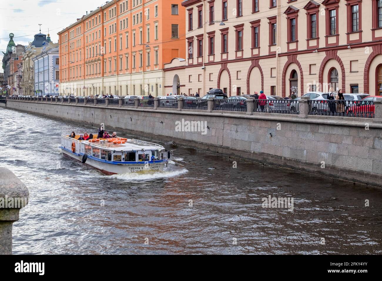 A pleasure boat sails along the Griboyedov Canal past historic buildings Stock Photo