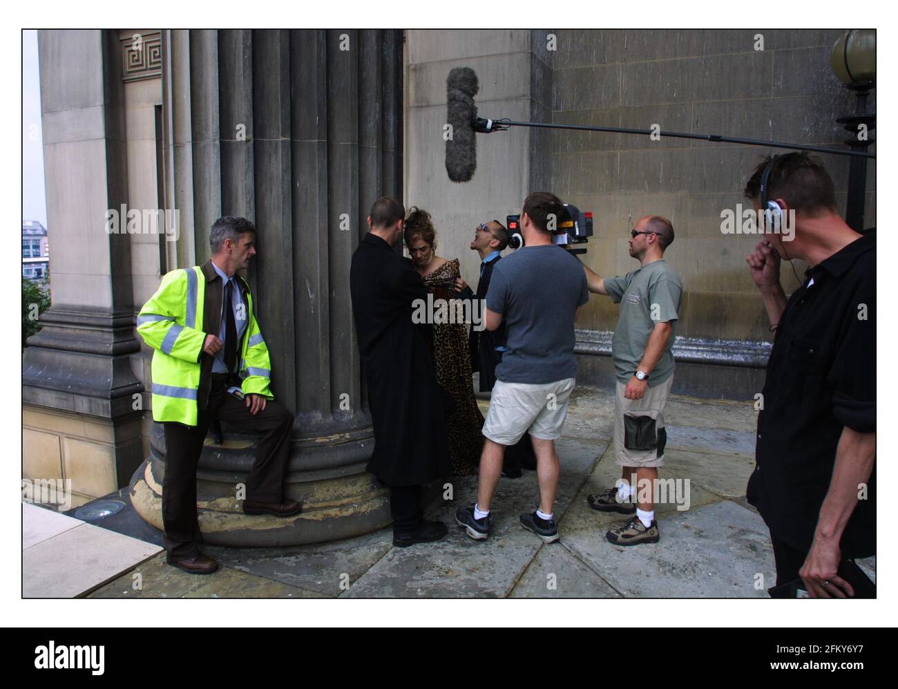 Filming of Revengers Tragedy   aug 2001 in and around St. Georges Hall, central Liverpool. Fraser Ayres as Spurio with Diana Quick as the Dutchess centre being filmed with Christopher Eccleston as Vindici (long black coat), Andrew Schofield as Carlo (lt) and director Alex Cox (far rt.) pic David Sandison 1/8/2001 Stock Photo
