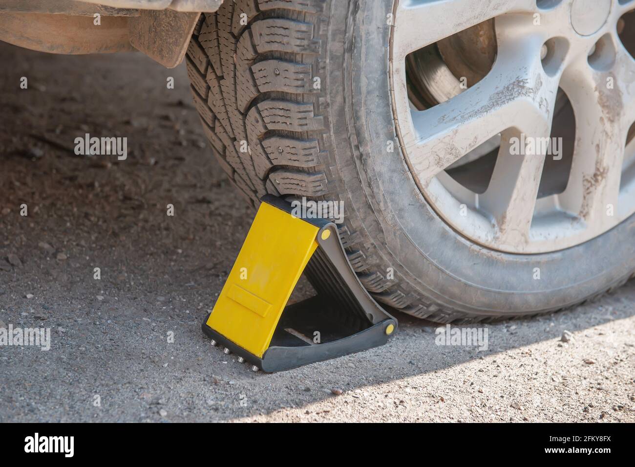 wheel chocks for restricting movement under the wheel of the car