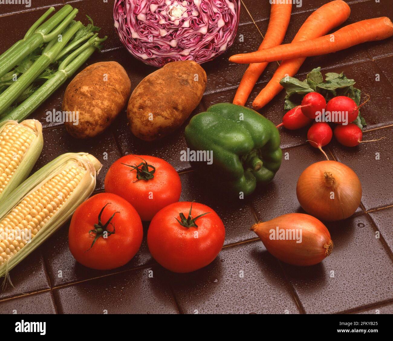 FOOD vegetables variety corn green pepper carrots radishes shallots tomatoes potatoes red cabbage celery Stock Photo