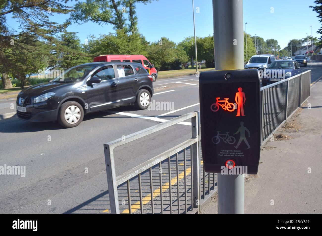 Red pedestrian traffic light on a busy road in Wales UK Stock Photo - Alamy