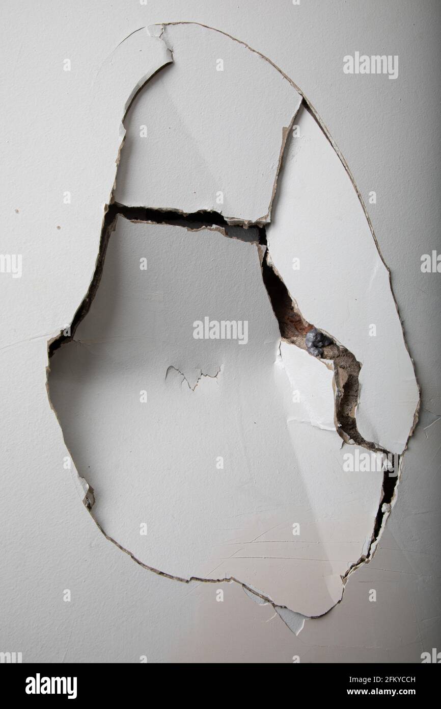 Broken plasterboard wall with a big crack on it Stock Photo Alamy
