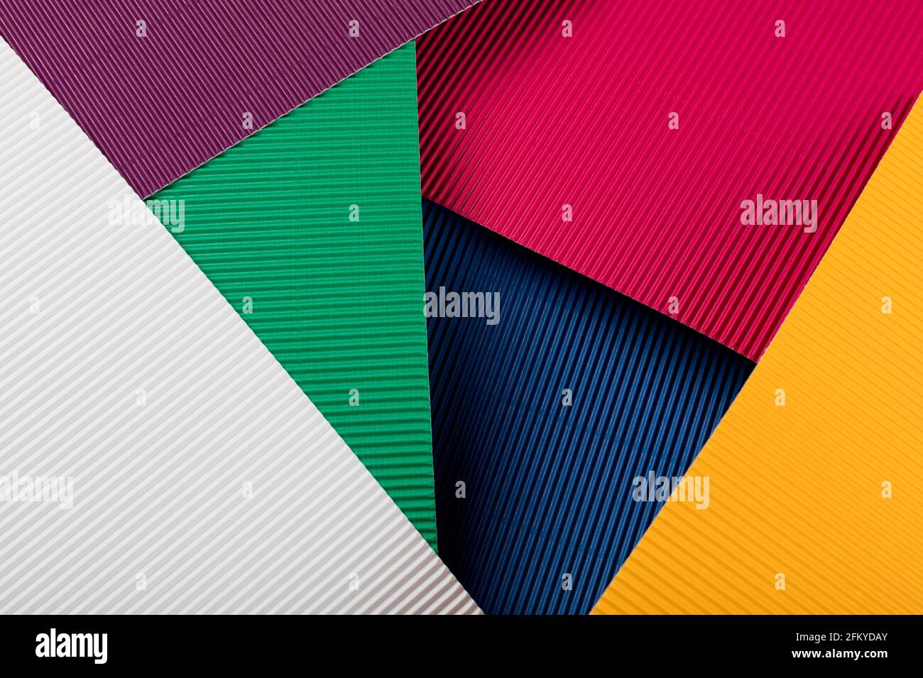 Colored corrugated paper texture. Geometric shapes and lines. Minimalist background. Flat lay. Copy space. Stock Photo