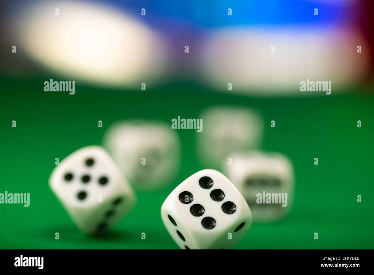 White dice on green felt table close up Stock Photo