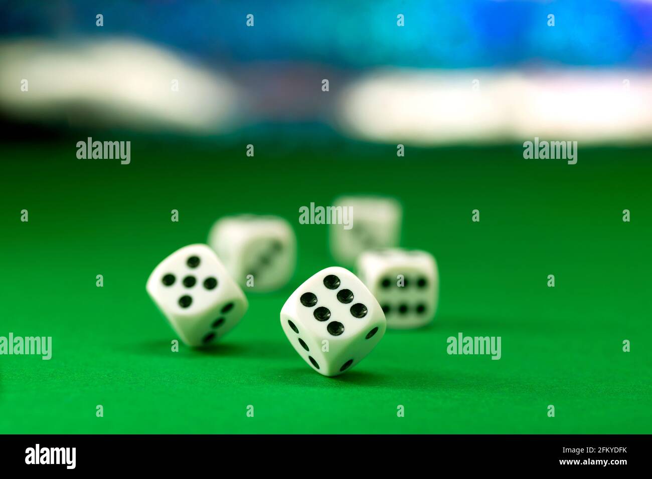White dice on green felt table close up Stock Photo