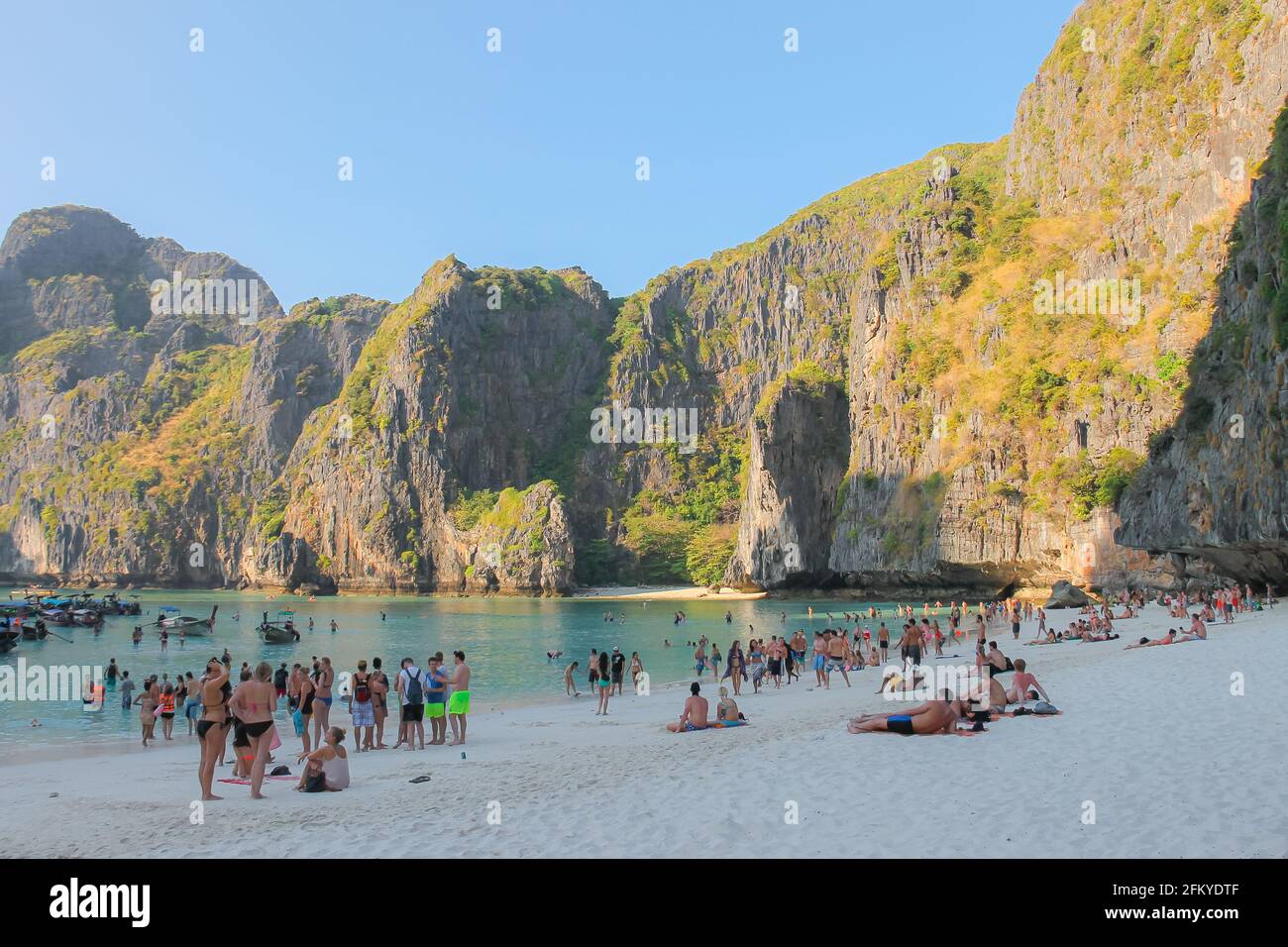 Phi Phi, Thailand - February 19 2014: Tourists visiting the popular sandy beach of Maya Beach on Ko Phi Phi Lee in the Phi Phi islands on the Andaman Stock Photo