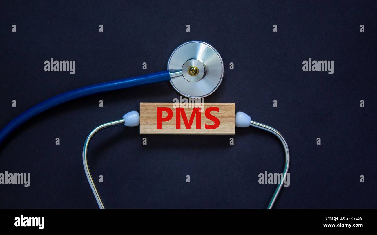 Medical and PMS, premenstrual syndrome symbol. Wooden block with the ...