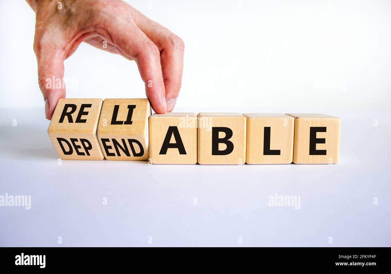 Dependable or reliable symbol. Businessman turns wooden cubes and changes  the word dependable to reliable. Beautiful white background, copy space.  Bus Stock Photo - Alamy