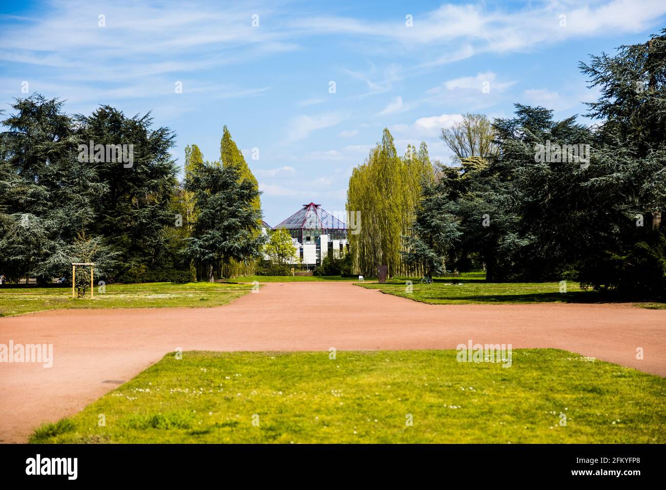Urban park full of trees under the cloudy blue sky Stock Photo - Alamy