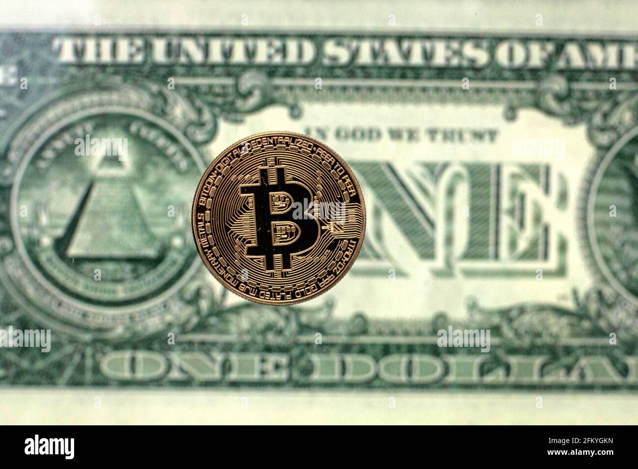 Spain. 04th May, 2021. In this Photo illustration, a Bitcoin is seen on a  background of a one dollar bill. Credit: SOPA Images Limited/Alamy Live  News Stock Photo - Alamy