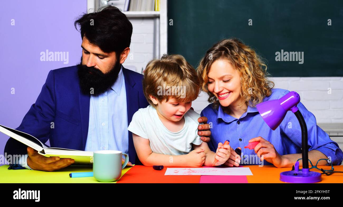 Parenting. Parents helping son to make homework. Family school. First time to school. Stock Photo