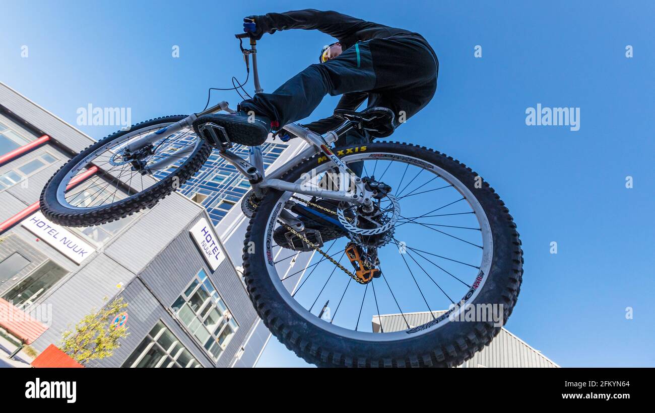 A biker in mid-air in the Capital City of Nuuk (Godthåb), southwestern Greenland. Stock Photo