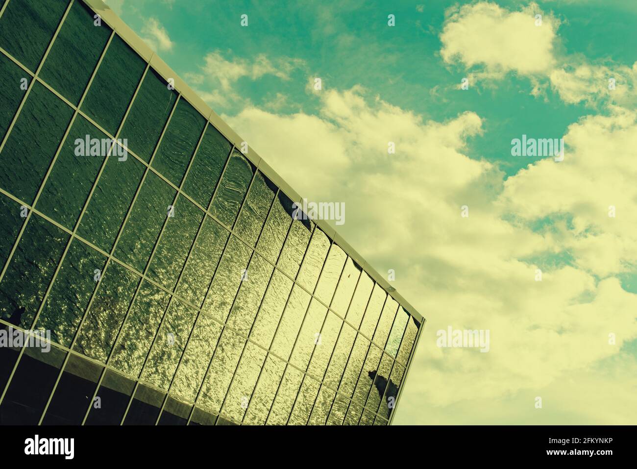 Dramatic lighting with glass facade building under a cloudy sky Stock ...