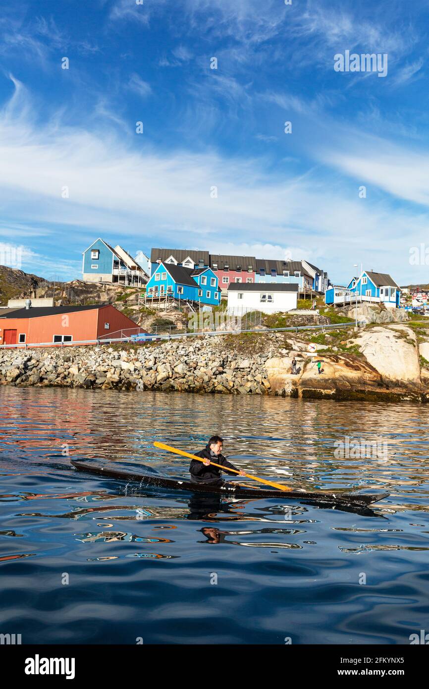 Local paddler demonstrates kayak techniques in the Greenlandic town of