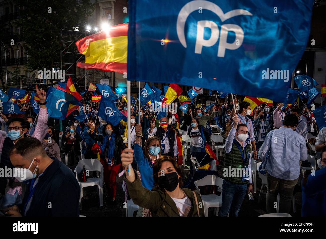 Madrid, Spain. 04th May, 2021. Supporters of Popular Party (PP) waving flags as they follow the results of the Regional elections of the Community of Madrid outside Popular Party Headquarters. Citizens of Madrid were called today for voting in regional elections and Popular Party Candidate Isabel Diaz Ayuso won a resounding victory with 45% of the votes. Credit: Marcos del Mazo/Alamy Live News Stock Photo