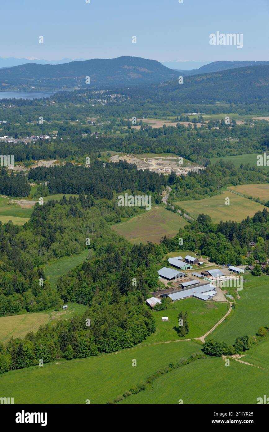 Aerial photo of farms in the Cowichan Valley with Cowichan Bay in the background, Duncan, Vancouver Island, British Columbia, Canada. Stock Photo