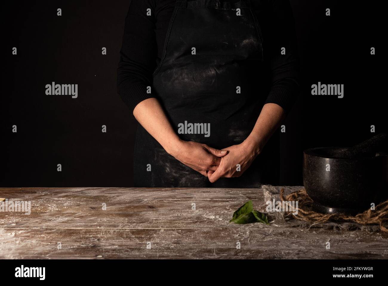 Lady standing behind floured table Stock Photo
