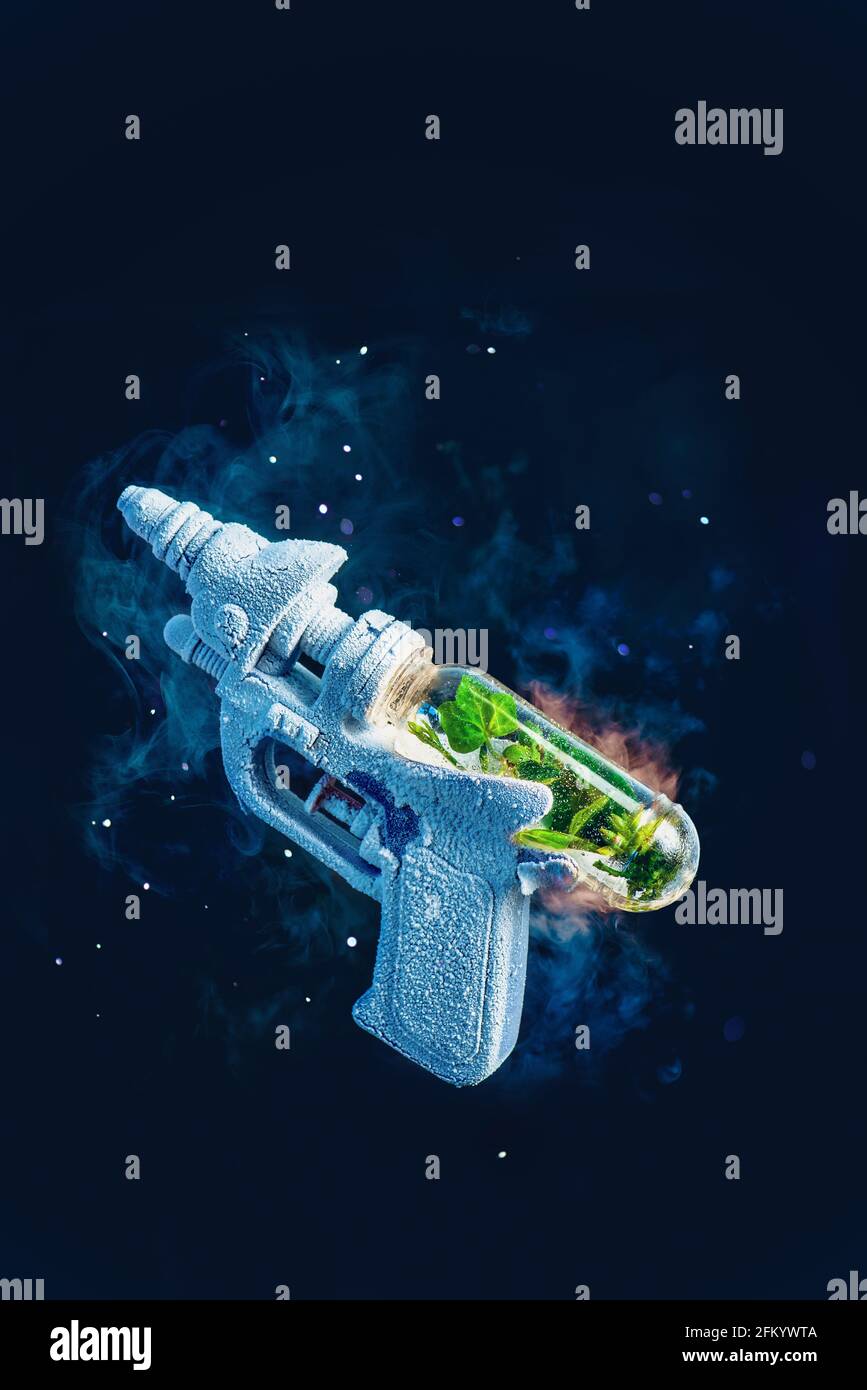 Frozen toy gun with a capsule of greenery inside, spring, rebirth, and ...
