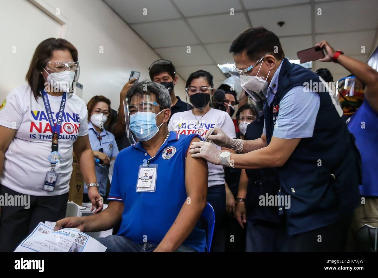 Manila, Philippines. 4th May, 2021. Philippine Health Secretary Francisco Duque administers a dose of the Russia-made COVID-19 vaccine 'Sputnik V' in the arm of a health worker in Manila, the Philippines, on May 4, 2021. Credit: Rouelle Umali/Xinhua/Alamy Live News Stock Photo