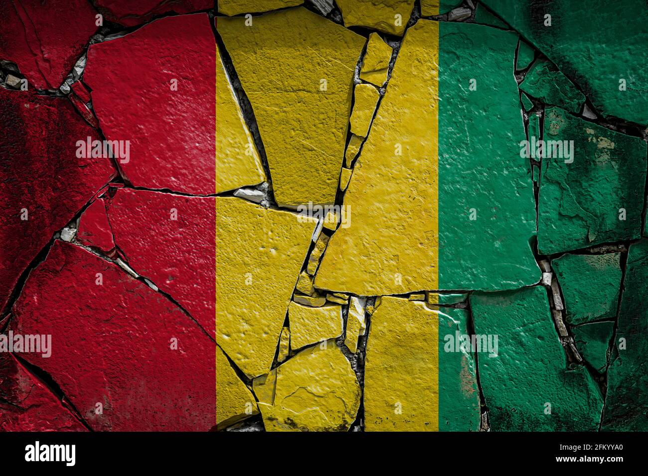 National flag of Guinea depicting in paint colors on an old stone wall ...